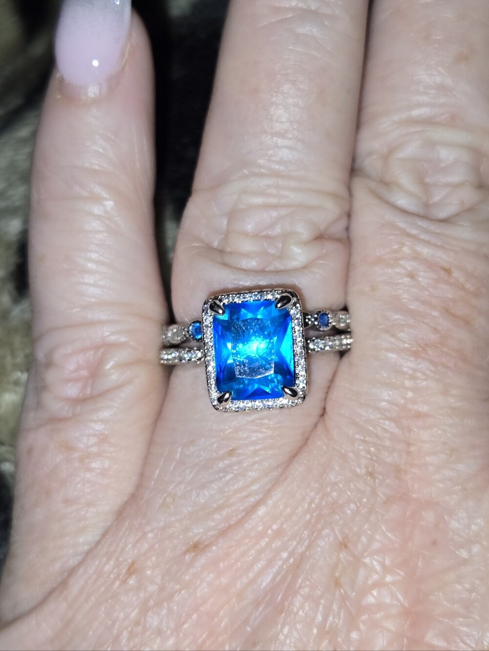 Blue Emerald-Cut Halo Ring with Accent Stones